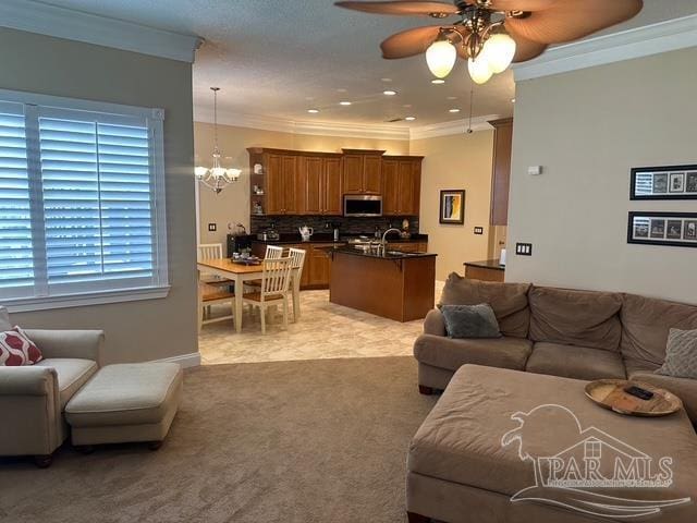 1988 Heritage Park Way, Navarre, FL 32566 - living room featuring ceiling fan, crown molding, a chandelier, and light carpet