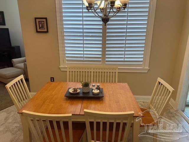 1988 Heritage Park Way, Navarre, FL 32566 - dining area featuring a chandelier