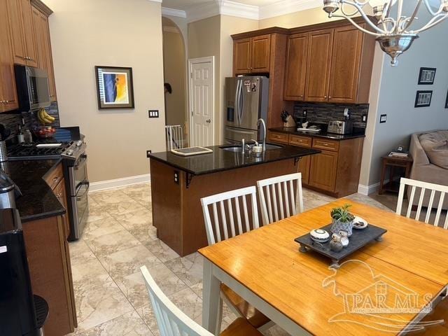 1988 Heritage Park Way, Navarre, FL 32566 - kitchen with appliances with stainless steel finishes, crown molding, a sink, dark countertops, and a chandelier