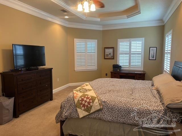1988 Heritage Park Way, Navarre, FL 32566 - bedroom with light colored carpet, ornamental molding, a tray ceiling, ceiling fan, and baseboards