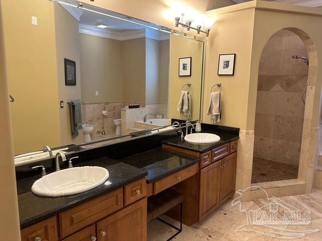 1988 Heritage Park Way, Navarre, FL 32566 - full bath featuring crown molding, toilet, double vanity, and tiled shower