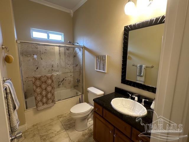 1988 Heritage Park Way, Navarre, FL 32566 - full bathroom featuring crown molding, toilet, vanity, and bath / shower combo with glass door