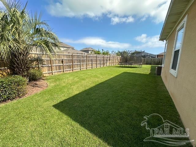 1988 Heritage Park Way, Navarre, FL 32566 - view of yard featuring a trampoline
