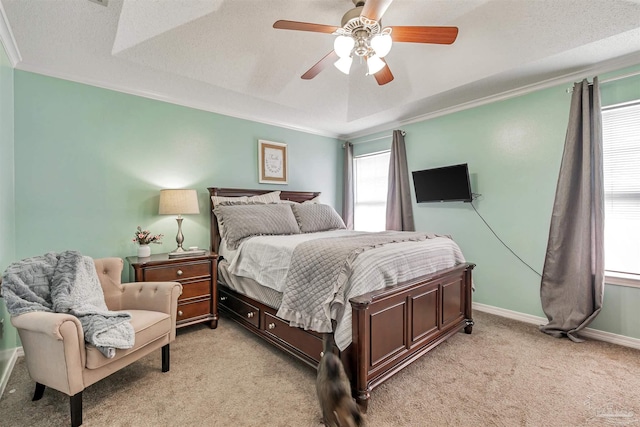 bedroom featuring light colored carpet, a ceiling fan, baseboards, and ornamental molding
