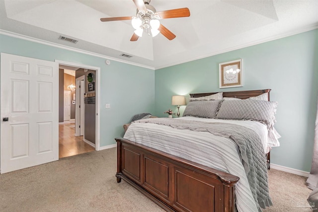 bedroom featuring a ceiling fan, visible vents, light colored carpet, and crown molding