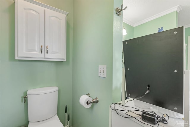 bathroom with crown molding and toilet