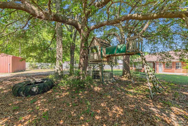 view of yard featuring an outbuilding and a playground