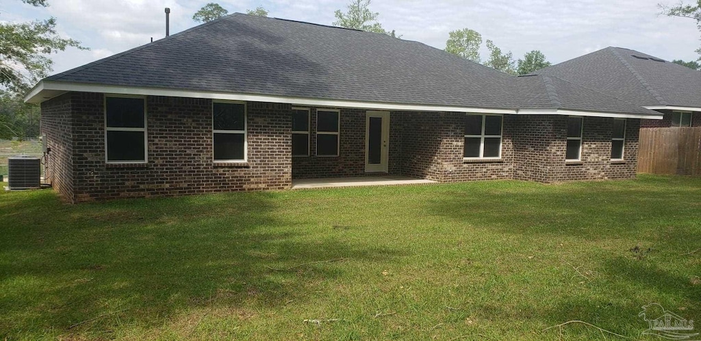 back of property featuring a patio, central air condition unit, and a lawn