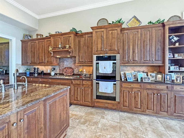 kitchen with extractor fan, tasteful backsplash, stainless steel appliances, and a sink