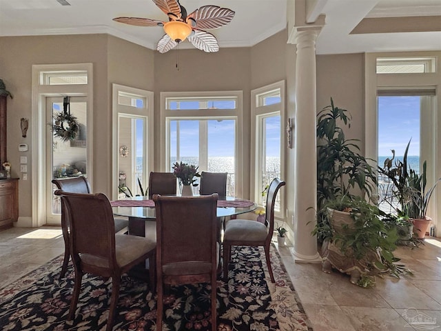 dining room featuring ornamental molding, plenty of natural light, decorative columns, and a ceiling fan