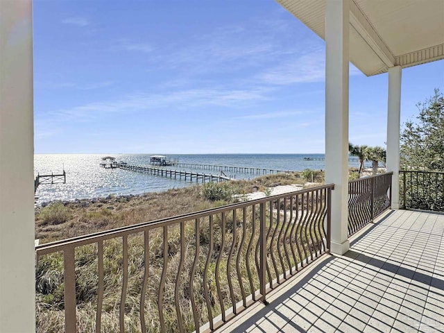 balcony featuring a water view and a view of the beach