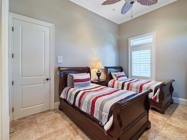 bedroom with ornamental molding, light tile patterned flooring, a ceiling fan, and baseboards