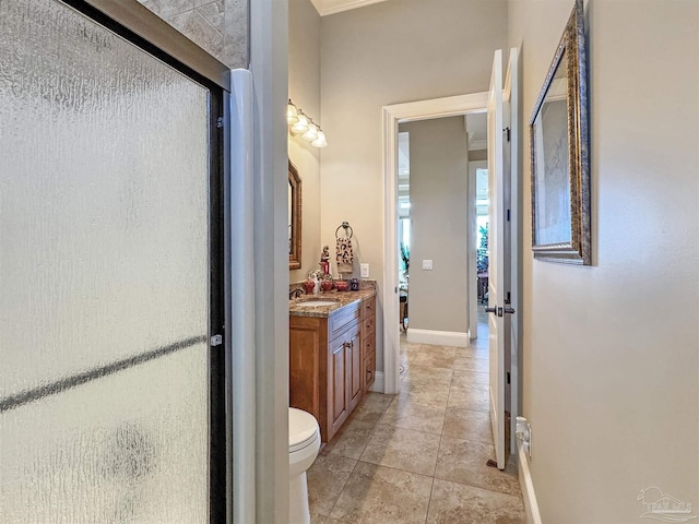 full bathroom with toilet, baseboards, vanity, and tile patterned floors