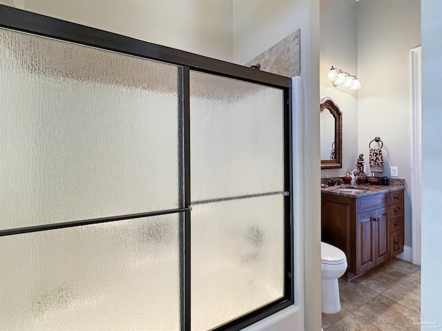 full bath featuring toilet, a shower with shower door, and vanity