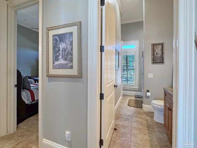 bathroom featuring tile patterned flooring, vanity, toilet, and baseboards