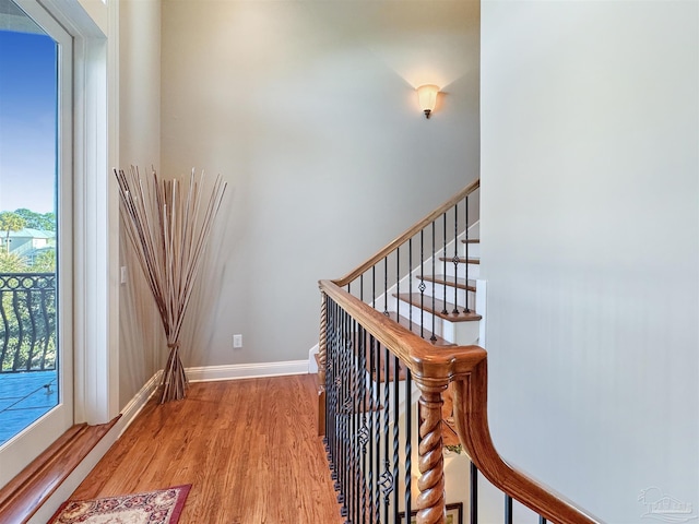 corridor featuring baseboards and wood finished floors