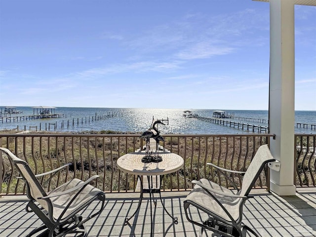 balcony featuring a water view and a beach view