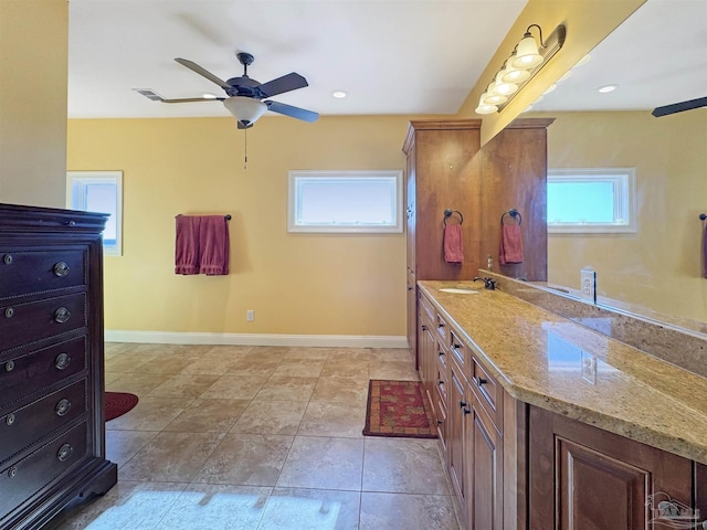 bathroom with recessed lighting, ceiling fan, vanity, and baseboards