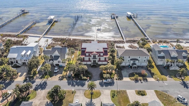 birds eye view of property with a water view and a residential view