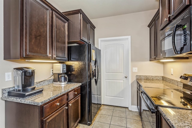 kitchen with light tile patterned floors, dark brown cabinets, black appliances, and light stone counters