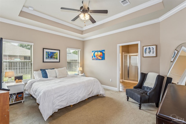 bedroom featuring visible vents, ornamental molding, baseboards, a raised ceiling, and light colored carpet