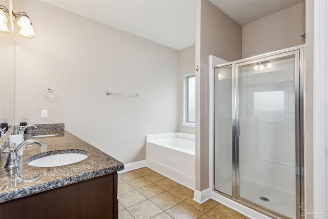 bathroom featuring tile patterned floors, a stall shower, and a sink