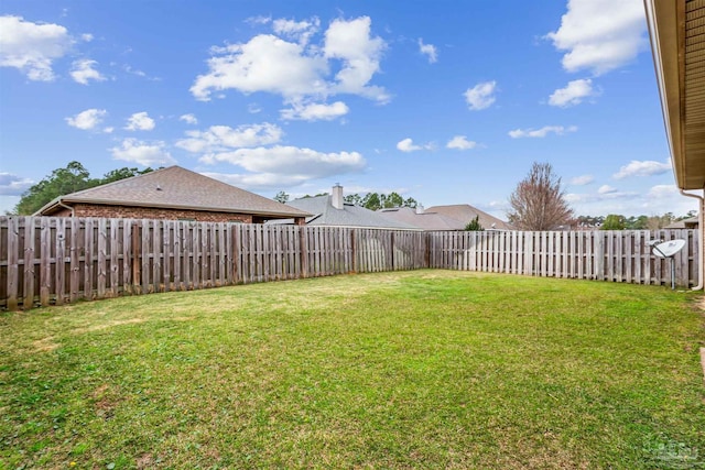 view of yard with a fenced backyard