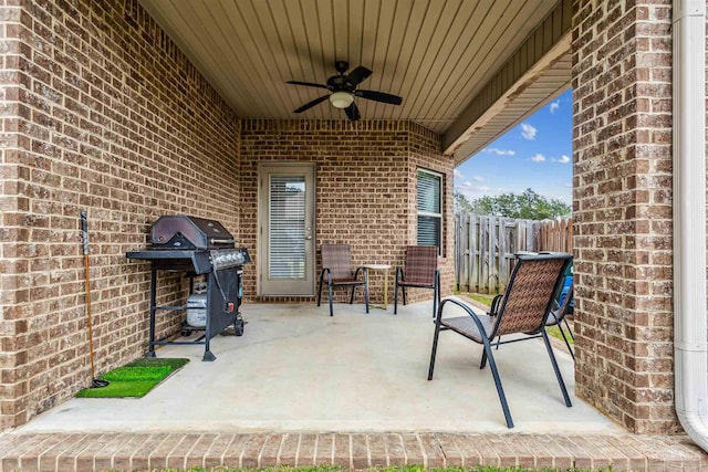 view of patio featuring ceiling fan, fence, and grilling area