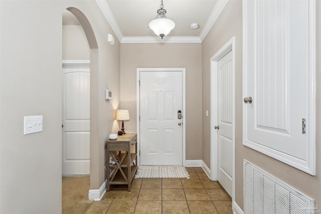 entryway with visible vents, arched walkways, crown molding, light tile patterned floors, and baseboards