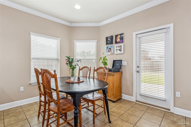 dining area featuring light tile patterned floors, baseboards, and ornamental molding