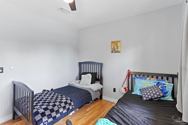 bedroom featuring light hardwood / wood-style floors and ceiling fan