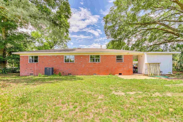 back of property with a lawn and a storage unit