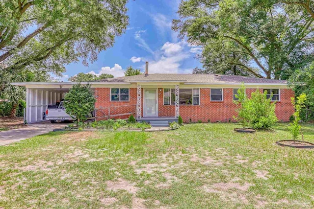 single story home featuring a carport and a front lawn