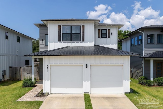 5611 Trout Ln, Pensacola, FL 32507 - view of front of property with board and batten siding, concrete driveway, a garage, and metal roof