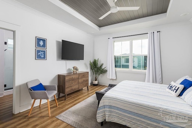 5611 Trout Ln, Pensacola, FL 32507 - bedroom featuring a tray ceiling, wood finished floors, and baseboards