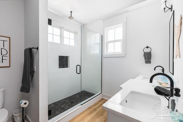 5611 Trout Ln, Pensacola, FL 32507 - full bath featuring toilet, a stall shower, wood finished floors, and double vanity