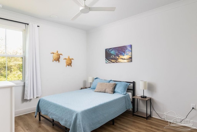 5611 Trout Ln, Pensacola, FL 32507 - bedroom featuring wood finished floors, multiple windows, a ceiling fan, and baseboards