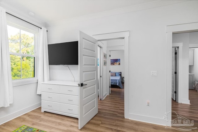 5611 Trout Ln, Pensacola, FL 32507 - bedroom featuring multiple windows, light wood-style flooring, and baseboards