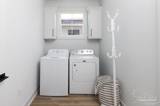 5611 Trout Ln, Pensacola, FL 32507 - laundry room featuring cabinet space, washer and clothes dryer, and wood finished floors