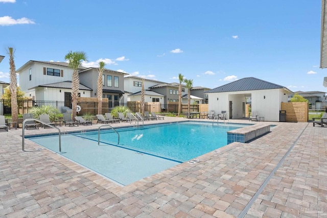 5611 Trout Ln, Pensacola, FL 32507 - community pool with a residential view and a patio