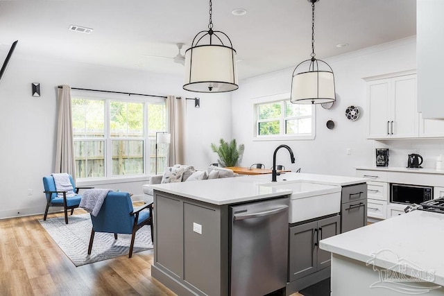5611 Trout Ln, Pensacola, FL 32507 - kitchen featuring dishwasher, a sink, light countertops, crown molding, and gray cabinetry