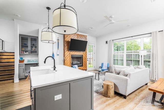 5611 Trout Ln, Pensacola, FL 32507 - living area featuring ceiling fan, stairs, light wood-style flooring, and a fireplace