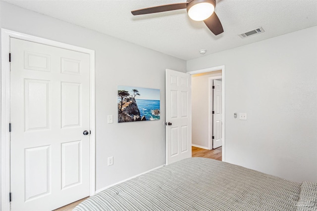 unfurnished bedroom featuring a ceiling fan and visible vents