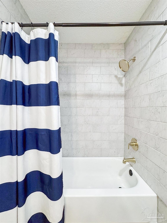 full bath featuring shower / bathtub combination with curtain and a textured ceiling