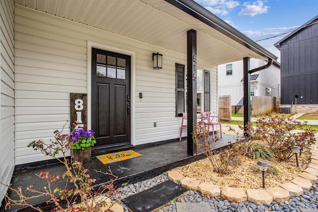 property entrance with a porch and central AC