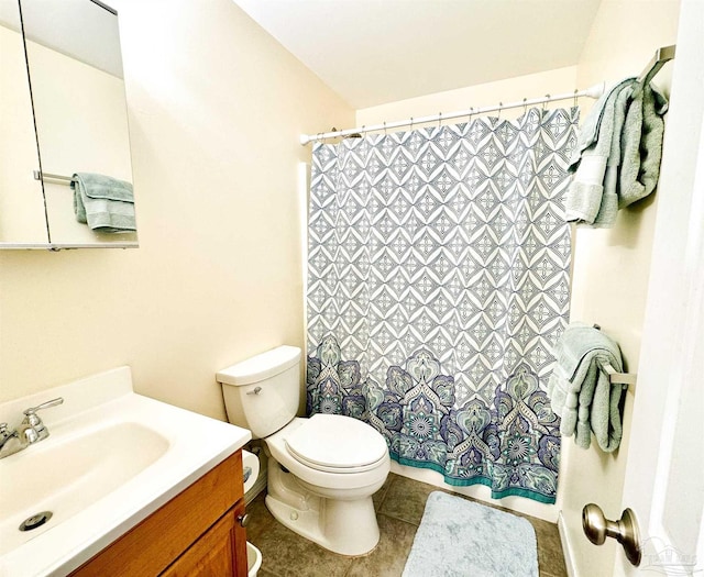 bathroom featuring tile patterned floors, vanity, and toilet