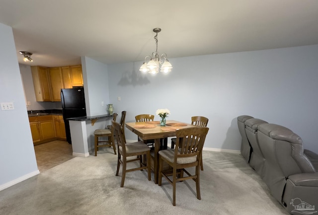 carpeted dining space featuring a chandelier and sink