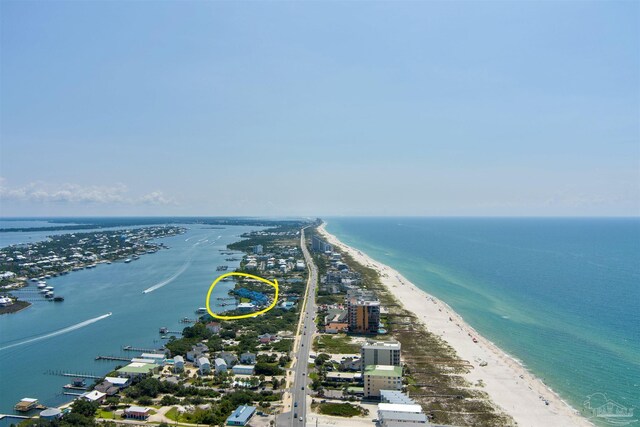 bird's eye view with a water view and a beach view