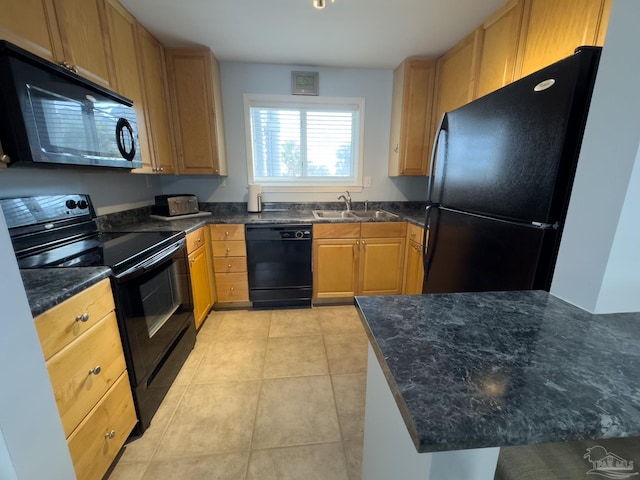 kitchen featuring light tile patterned floors, dark stone countertops, sink, and black appliances