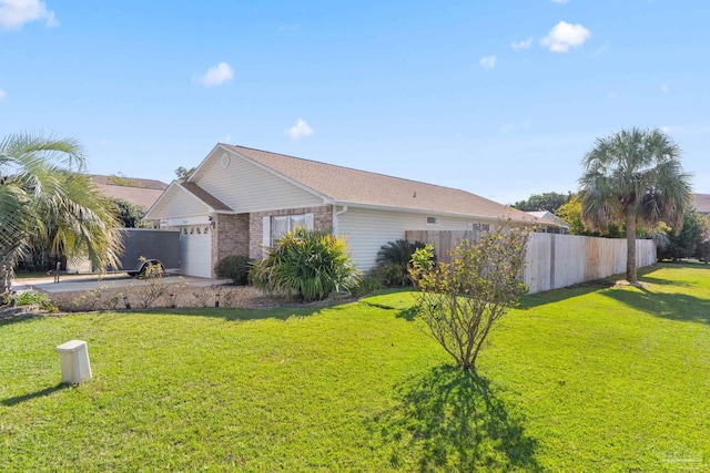 view of side of home with a yard and a garage